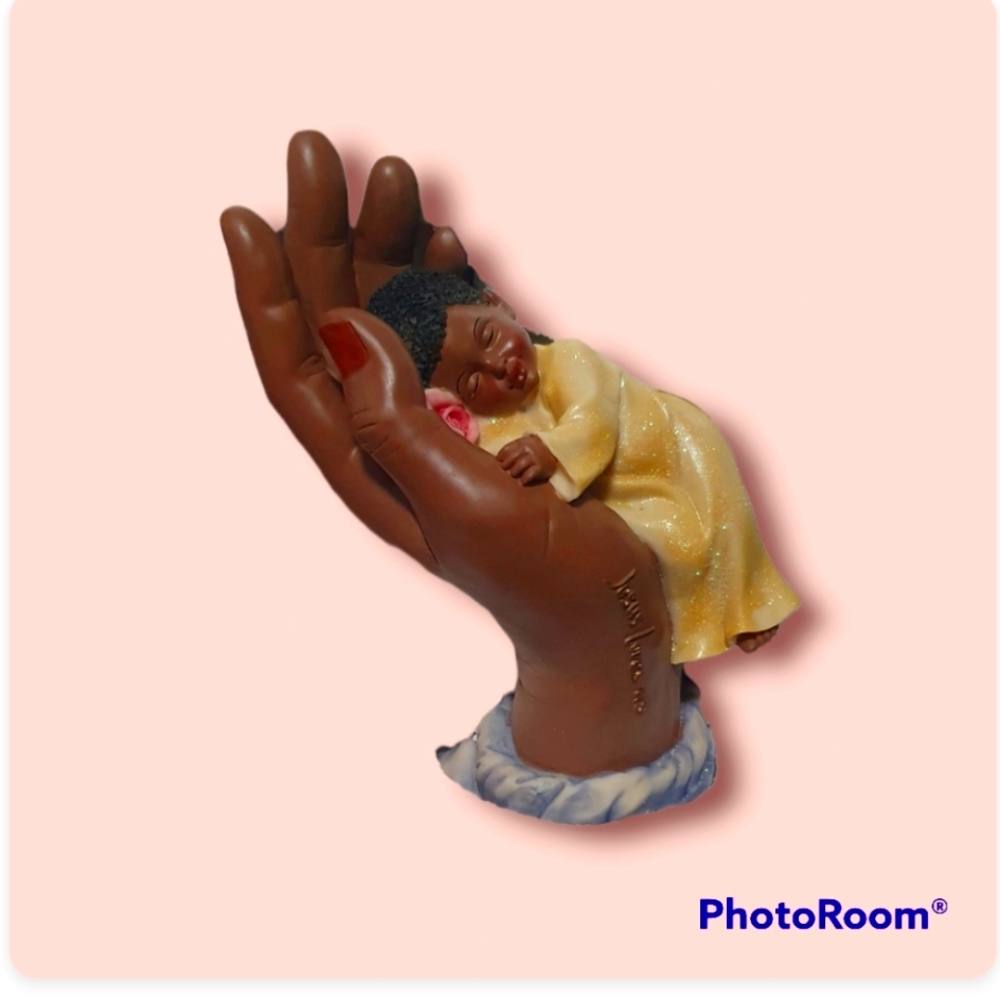 Sleeping baby in Lord's hand Statue